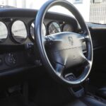 The steering wheel is in beautiful condition with no wear and tear, indicating that it has been treated with care.