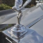 "The Spirit of Ecstasy" mascot by sculptor Charles Robinson Sykes is based on Nike.