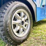 　12" mud-terrain tires and Minilite 8-spoke