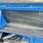 Glove box with CAGIVA MOKE logo visible, right hand side is a retractable drink holder
